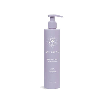 A lavender pump bottle of InnerSense Bright Balance Conditioner on a clean white background.