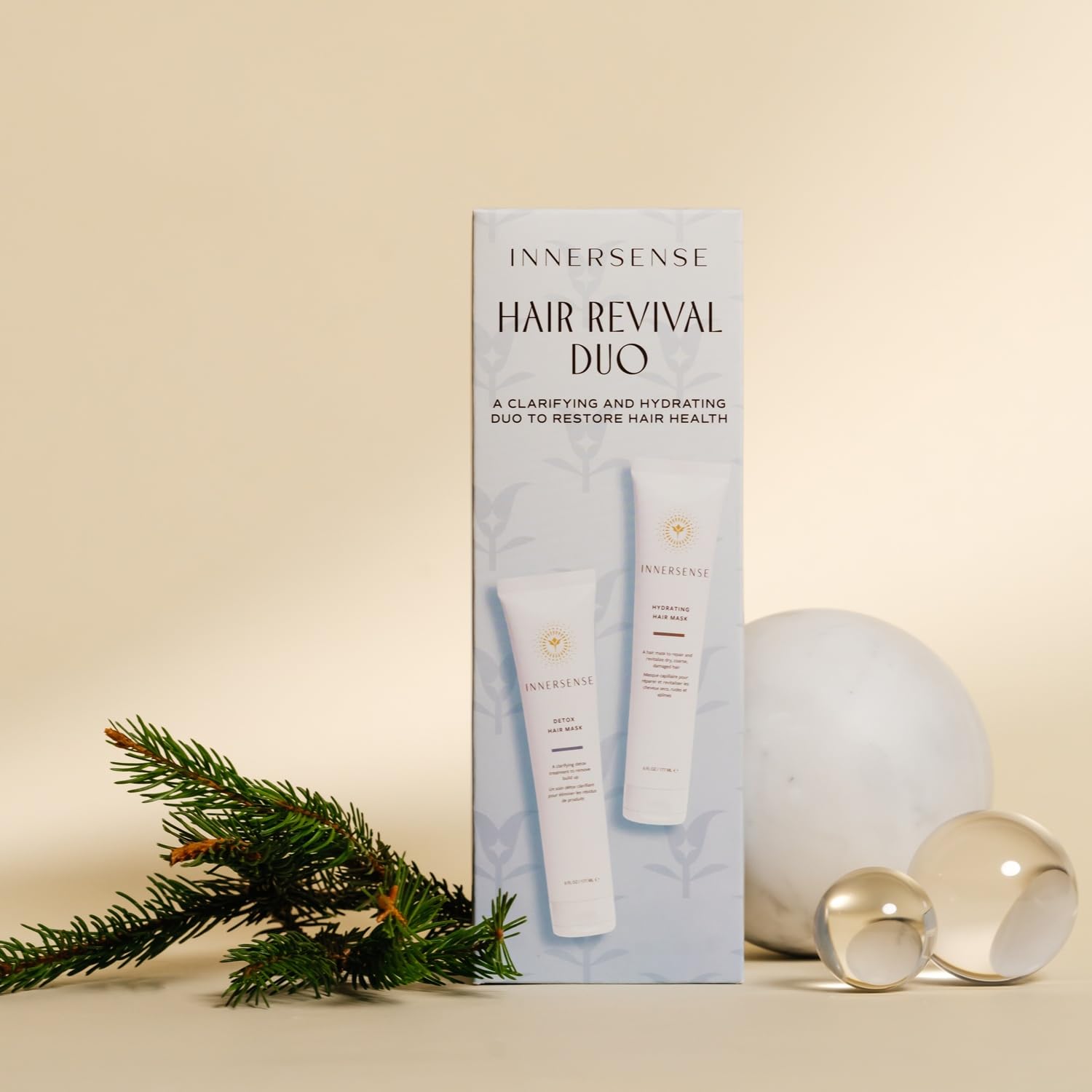Innersense Hair Revival Duo packaging with decorative elements on a beige background
