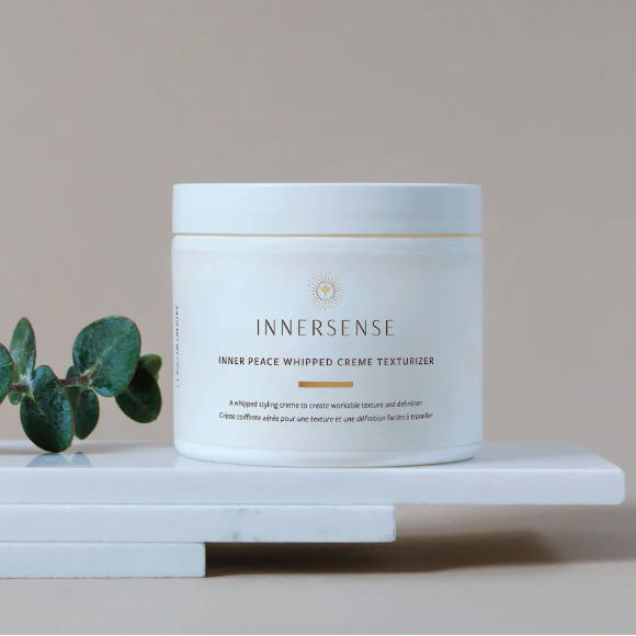 Innersense product on a white surface with a beige background