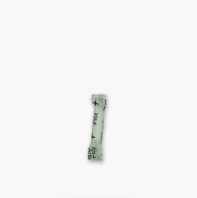 Small green tube with text on a white background