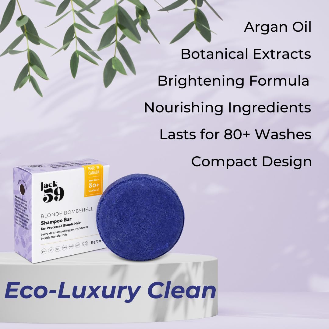 A shampoo bar product display featuring a round dark blue shampoo bar next to its white and purple packaging box, set on a pedestal with promotional text overlays and eucalyptus leaves.