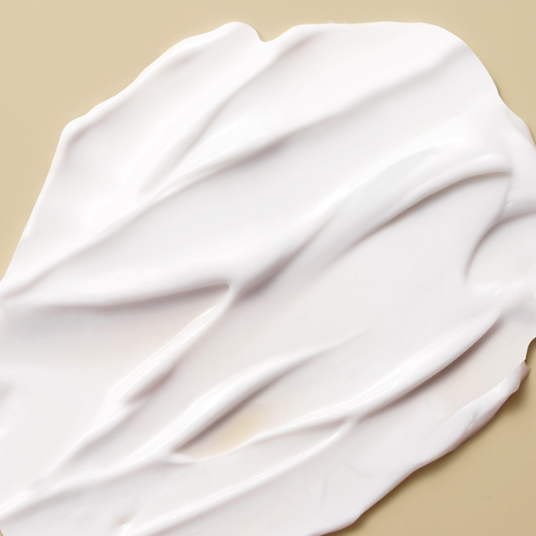 White lotion bottle with colorful text on a white background