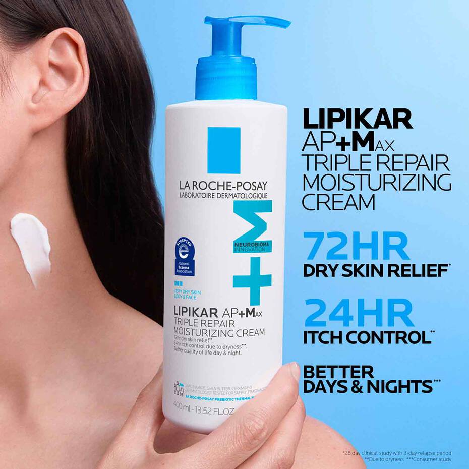 La Roche-Posay Lipikar AP+M Max cream bottle held by a person with blue background