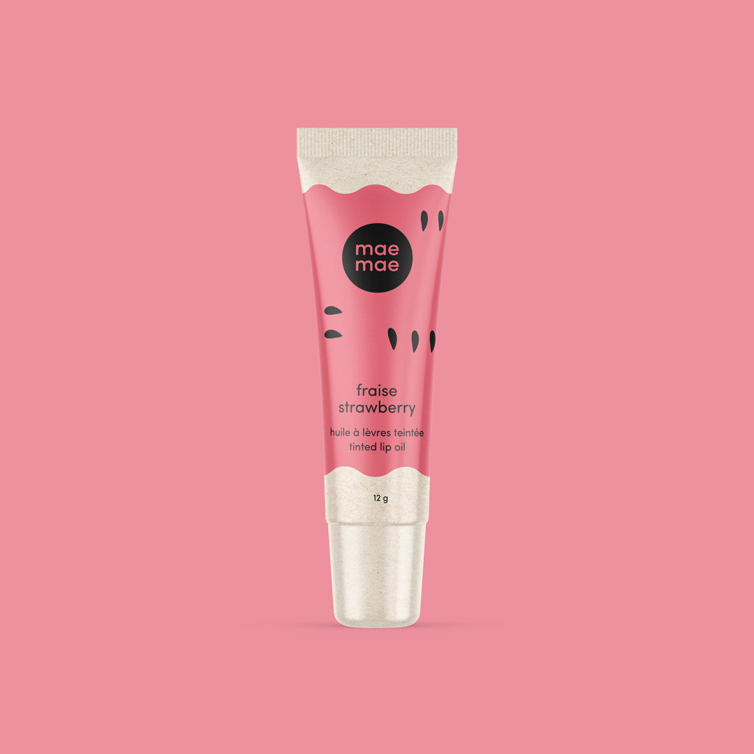 Pink lip oil tube with 'mae mae' branding on a pink background