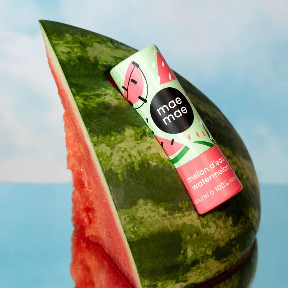 Watermelon with a 'mae mae' brand label against a blue sky background