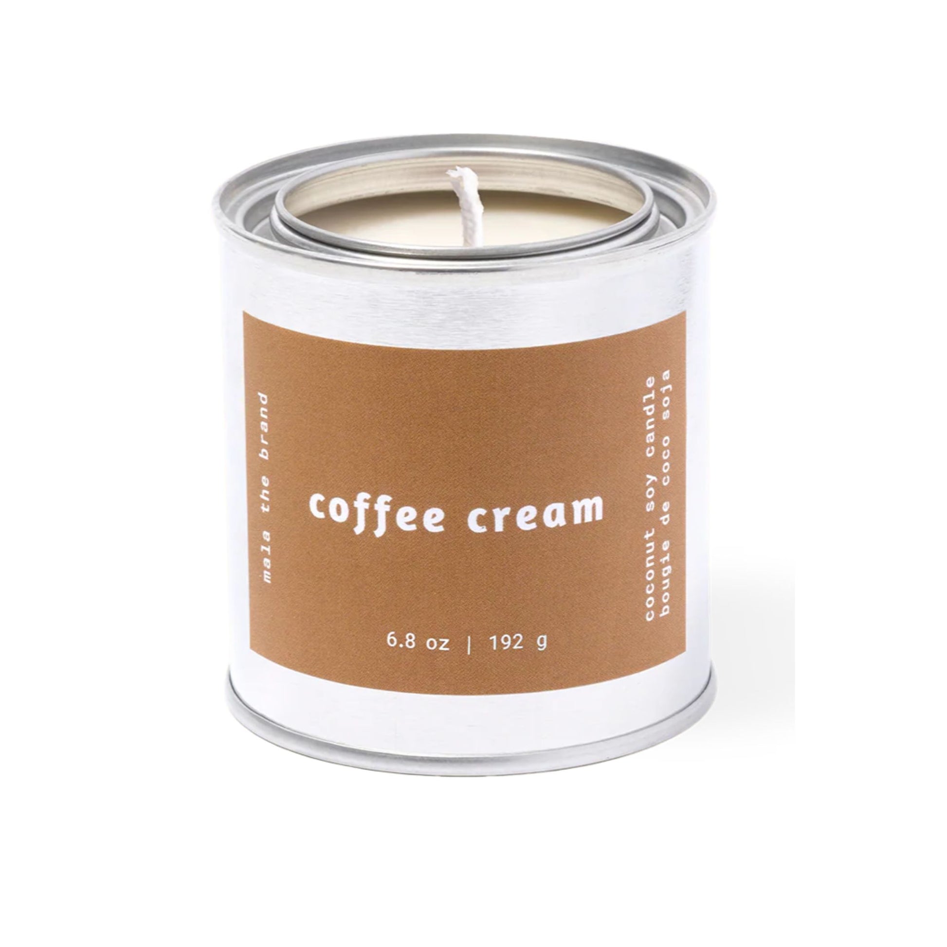 Candle in a can labeled 'coffee cream' on a white background