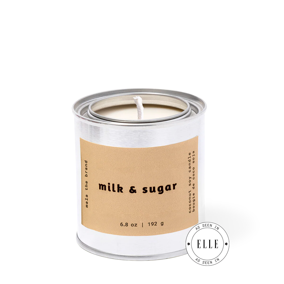 Candle in a metal can with 'milk & sugar' label on a white background