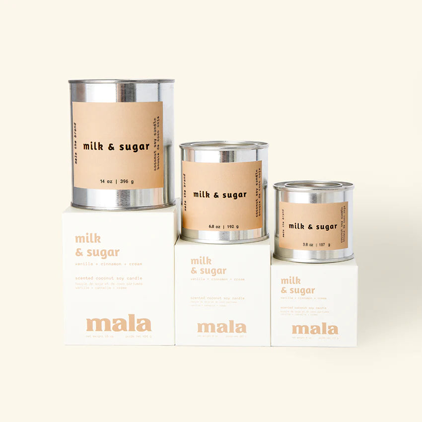 Three 'milk & sugar' candles with 'mala' branding on a white background