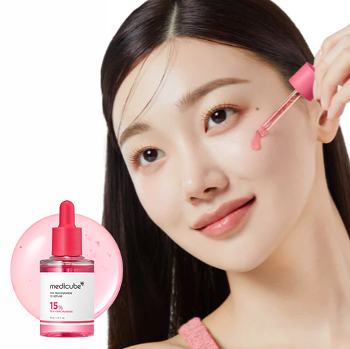 Woman applying skincare product with Medicube dropper bottle inset