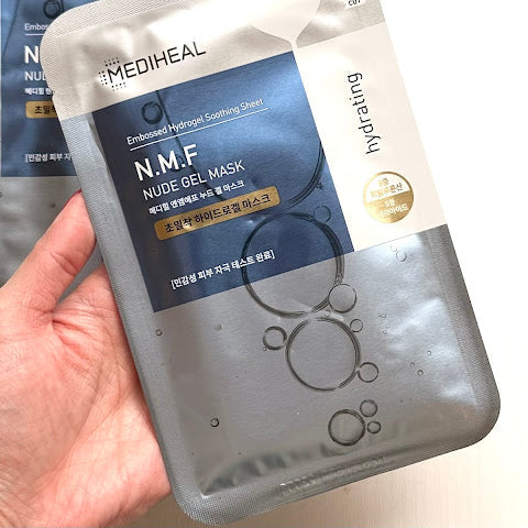 MEDIHEAL NMF Nude Gel Mask Sheet held in hand, available at The Pharmacy Lab for deep hydration and dry skin care.