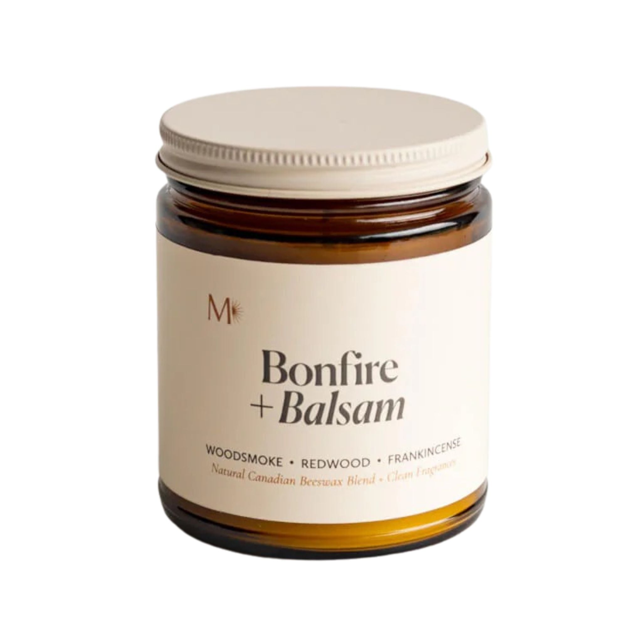 Candle jar labeled 'Bonfire + Balsam' with a white lid on a white background