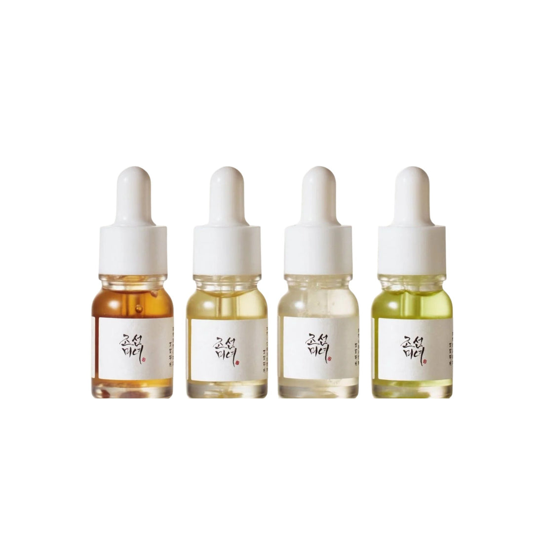 Four dropper bottles with different colored liquids on a white background