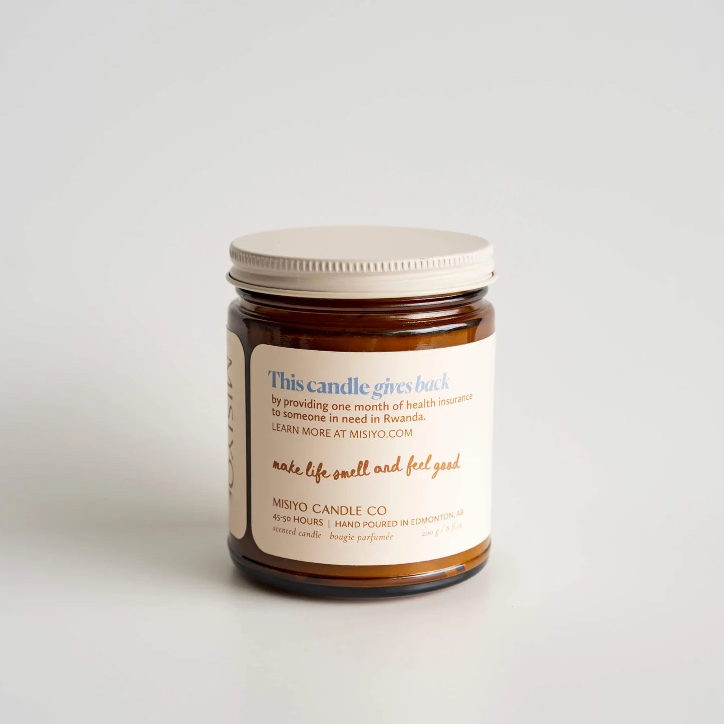 Jar of candle with a label on a light gray background