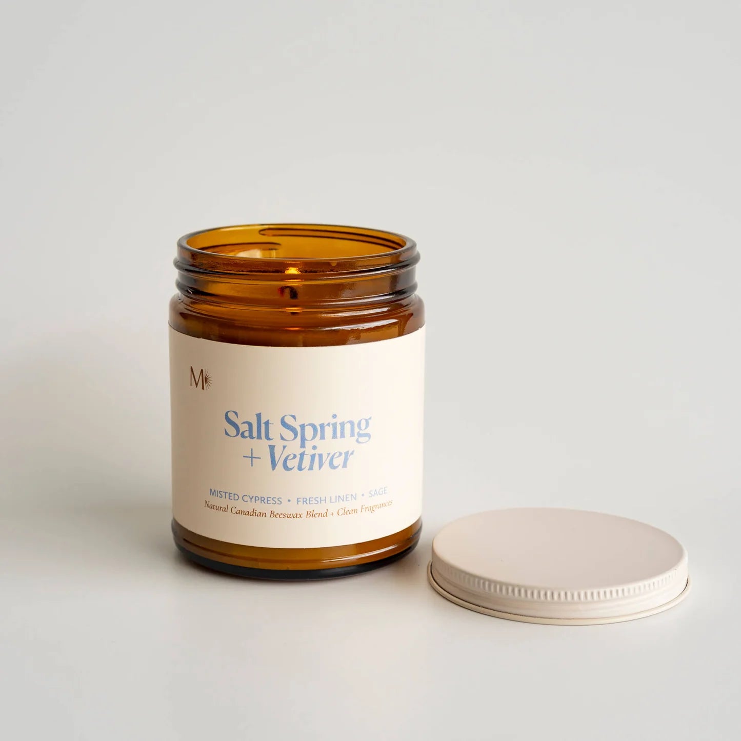 Candle jar labeled 'Salt Spring + Vetiver' with a white label on a light background