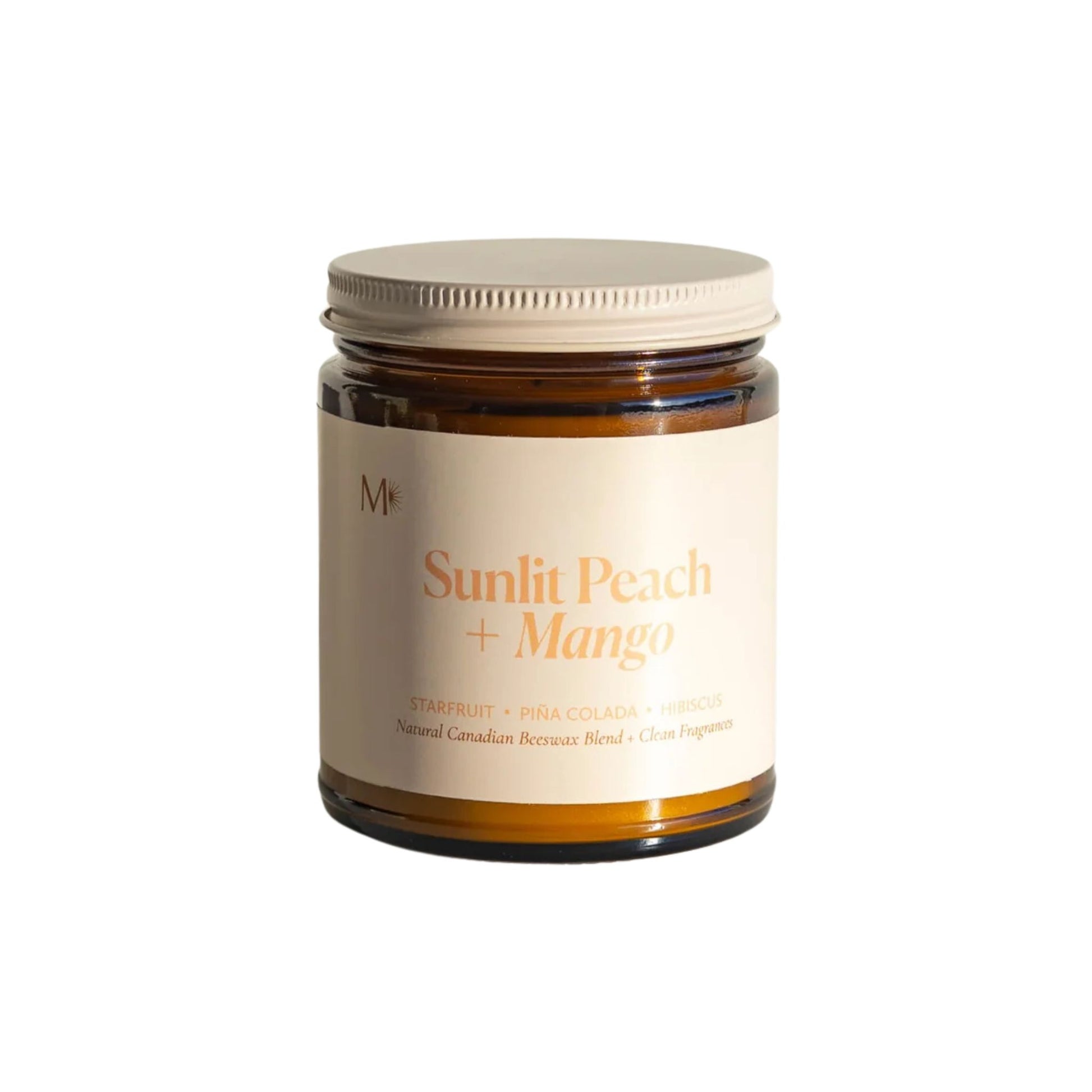 Jar of 'Sunlit Peach + Mango' candle on a white background