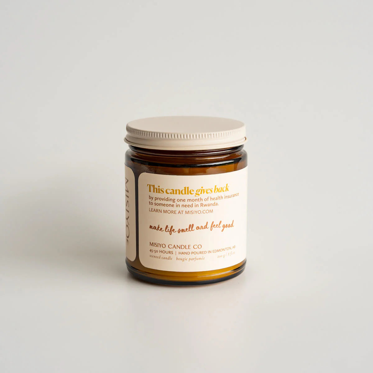 Jar candle with a label on a light gray background