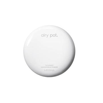 Round white device with buttons on a white background