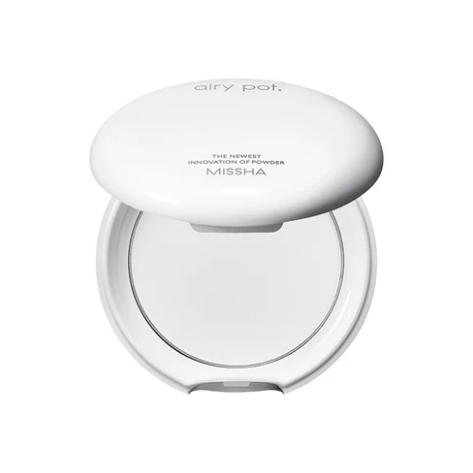 White compact powder case with 'Missha' branding on a white background