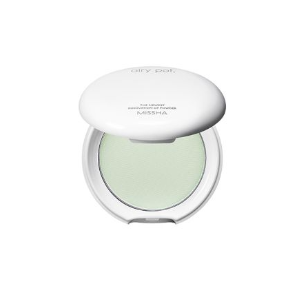 Missha air puff compact with green powder on a white background