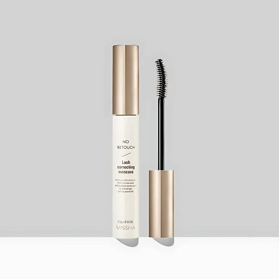 Lash correcting mascara with gold cap and black wand on a light gray background