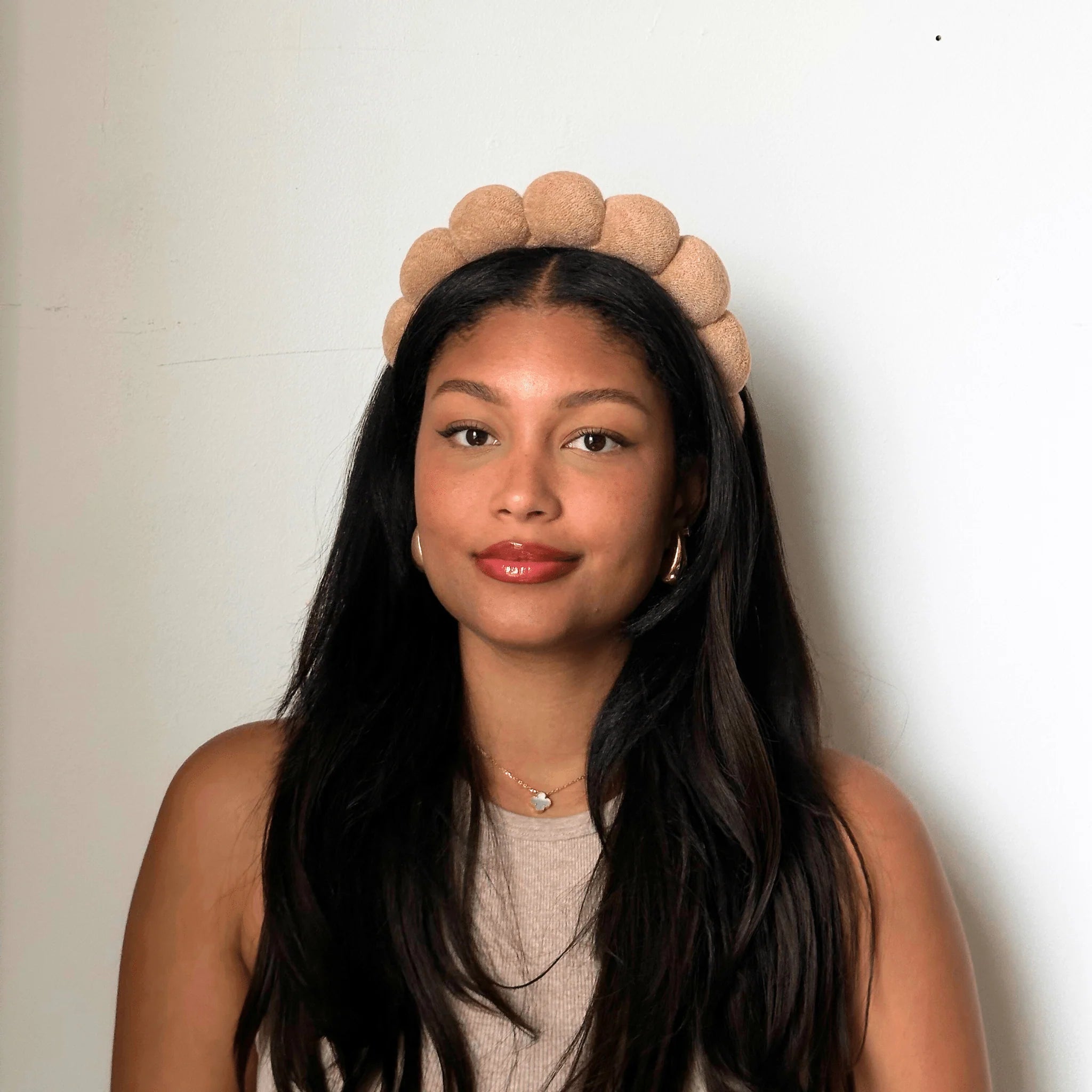 Front portrait of model wearing The Pharmacy Lab NUDA GRWM Terry Headband styled for beauty routines, facials, and everyday self-care