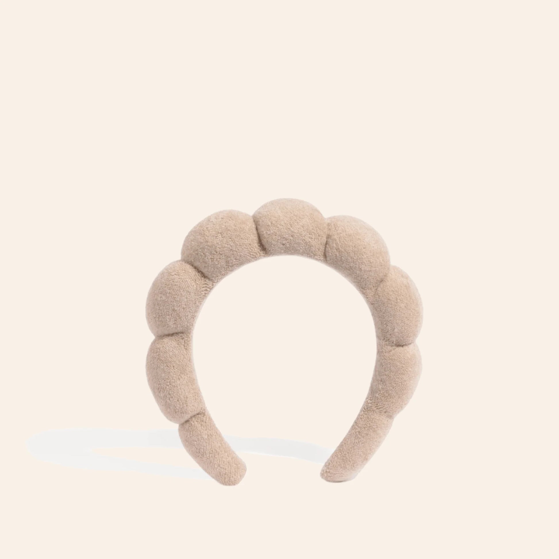 The Pharmacy Lab NUDA GRWM Terry Headband in soft neutral beige with plush padded terry fabric for skincare, makeup, and self-care routines