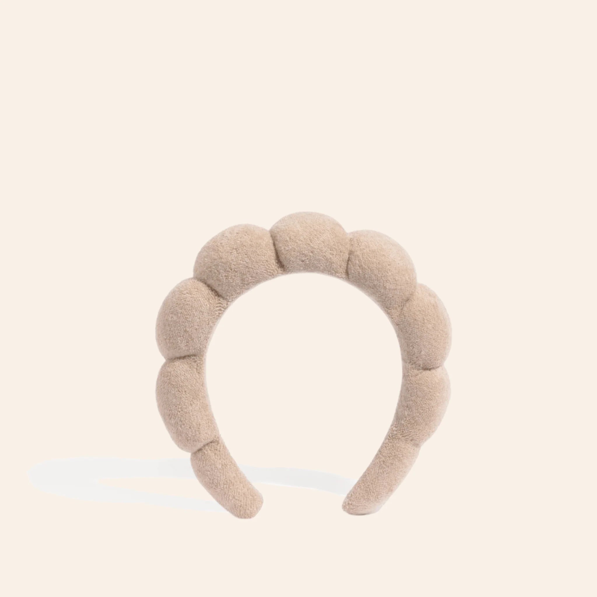 The Pharmacy Lab NUDA GRWM Terry Headband in soft neutral beige with plush padded terry fabric for skincare, makeup, and self-care routines