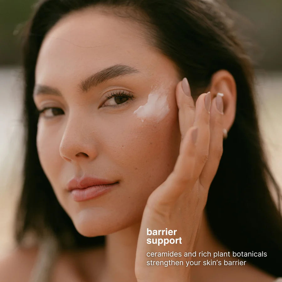 Woman applying cream to her face with a blurred background