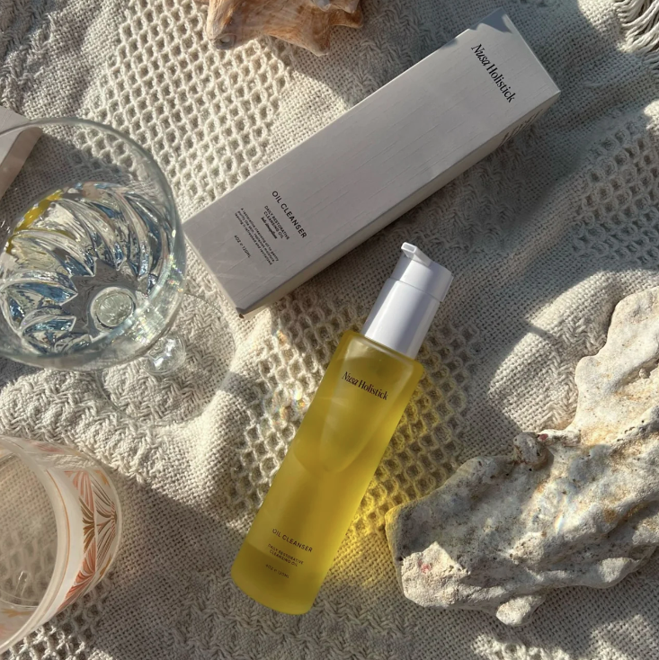 Yellow bottle of Alvar Holistic Oil Cleanser on a white background