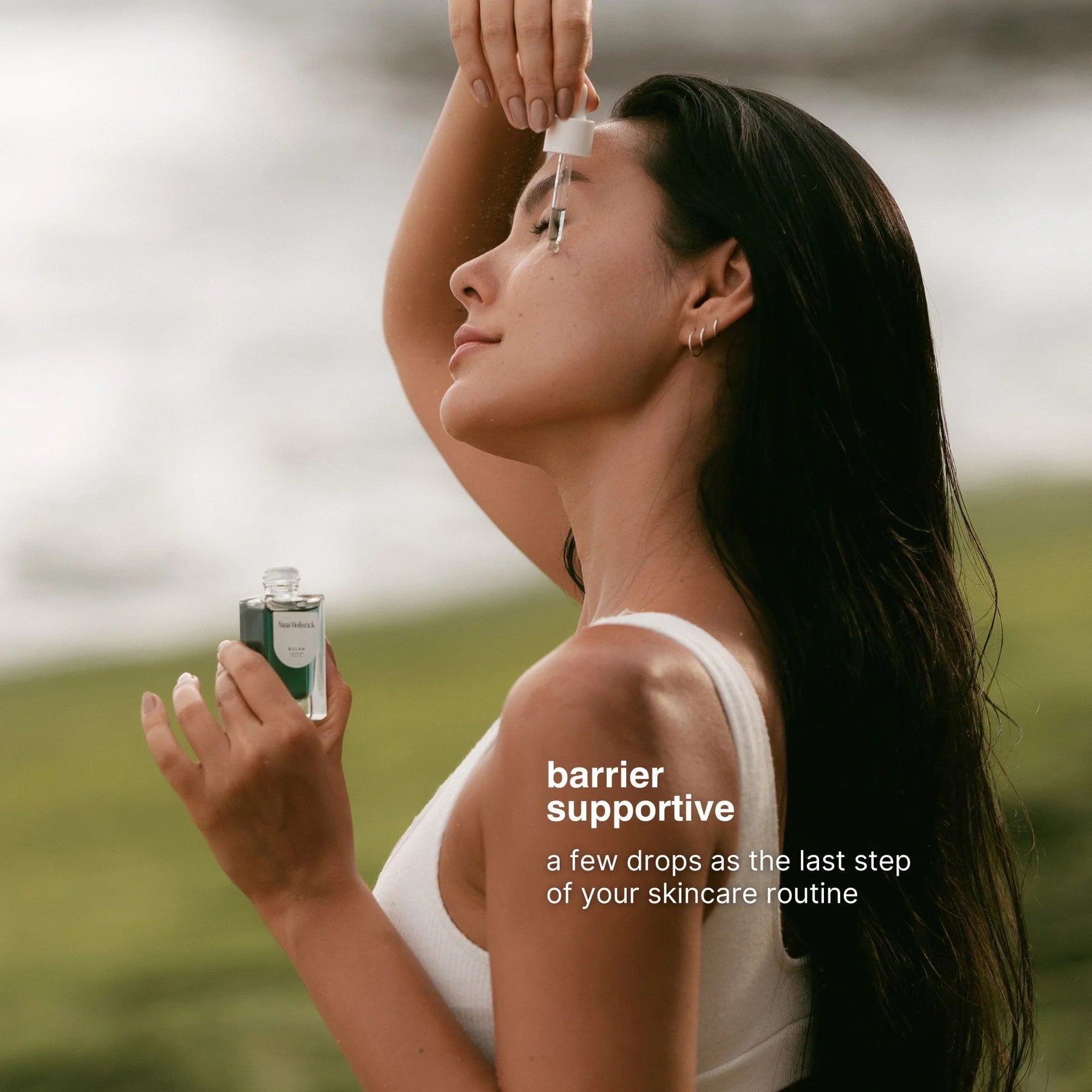 Woman applying a skincare product outdoors with text about barrier support.