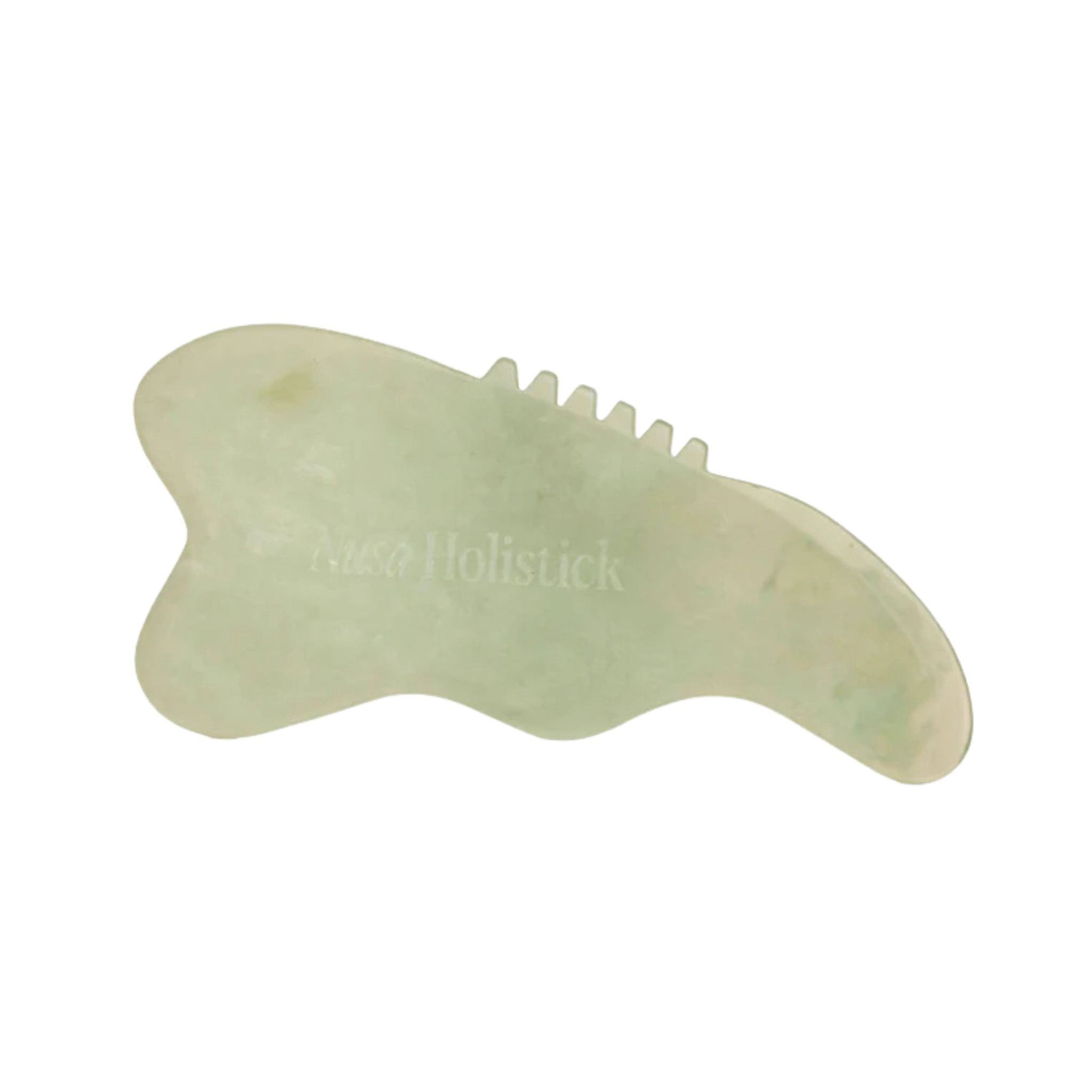Green jade gua sha tool on a white background