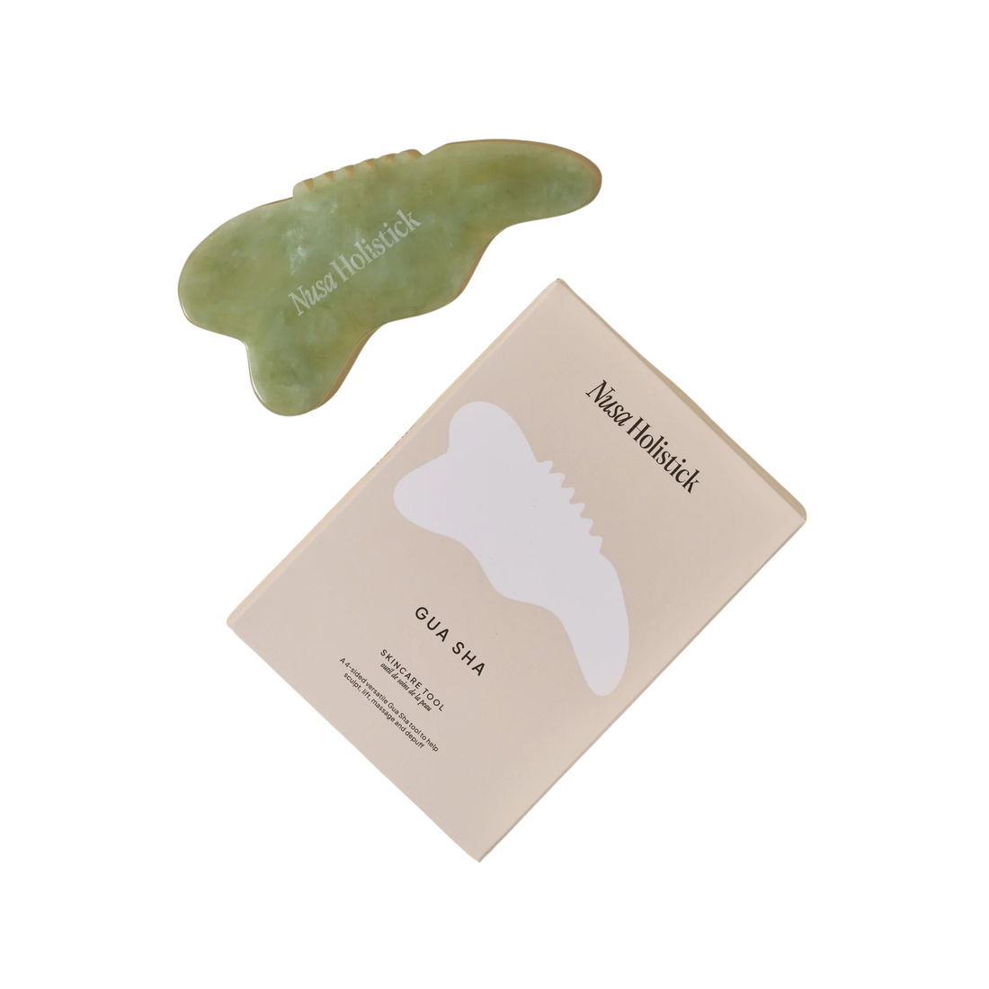 Green jade gua sha tool on a white background