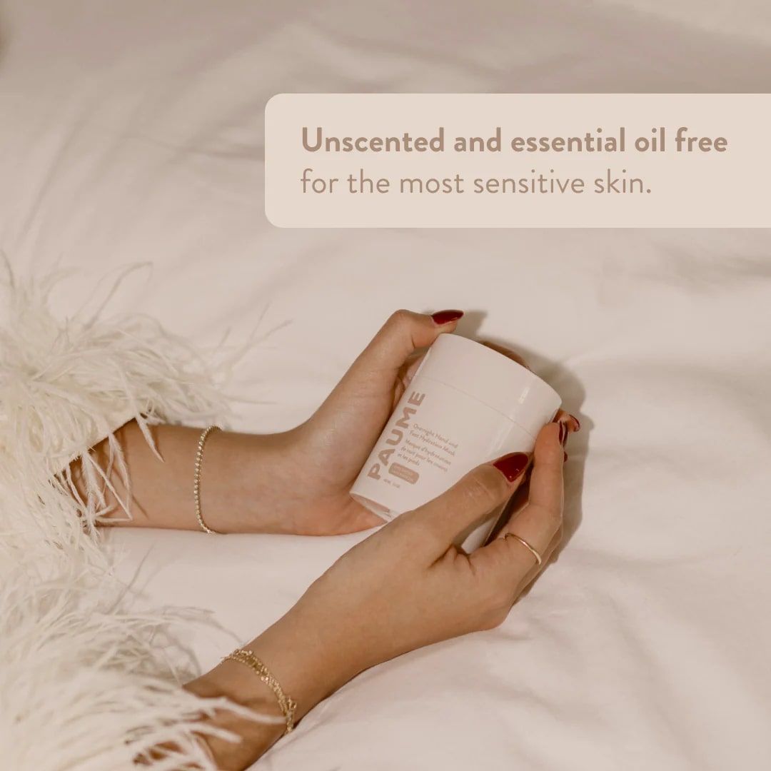 Hand holding a container of skincare product with text about unscented and essential oil-free options for sensitive skin.