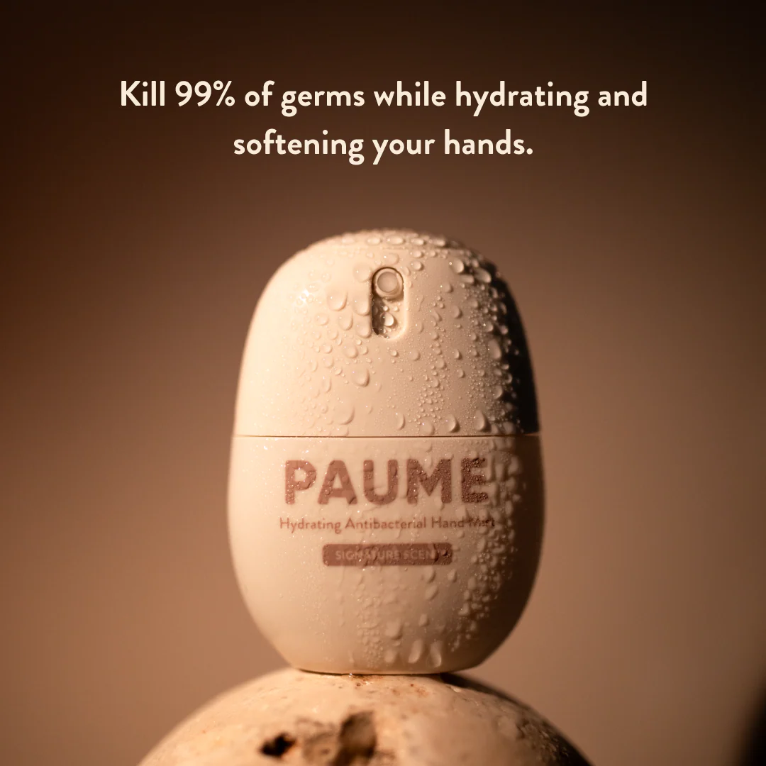 PAUMER hand sanitizer bottle with text on a brown background