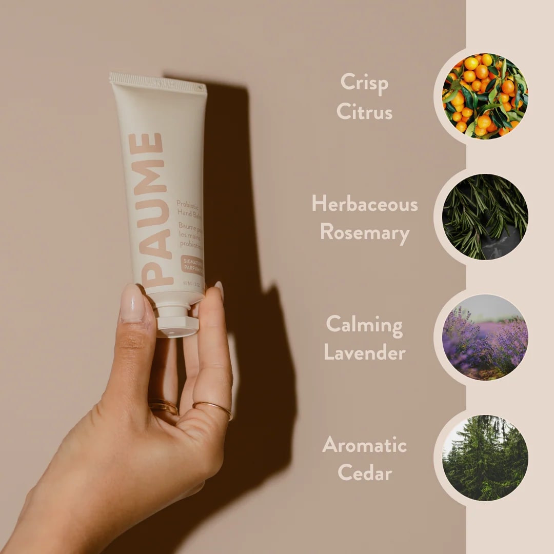 Hand holding a PAUME skincare product with scents listed on a beige background