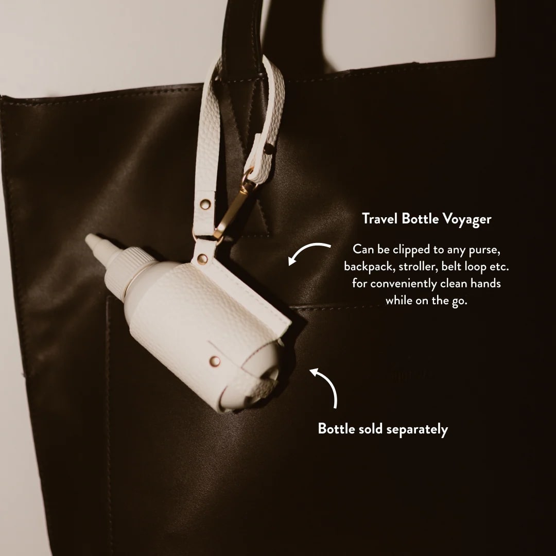 Travel bottle holder clipped to a black bag with text describing its use.