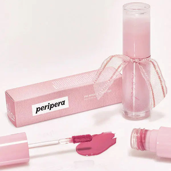 Pink lip gloss with applicator and packaging on a white background, featuring the Peripera brand.