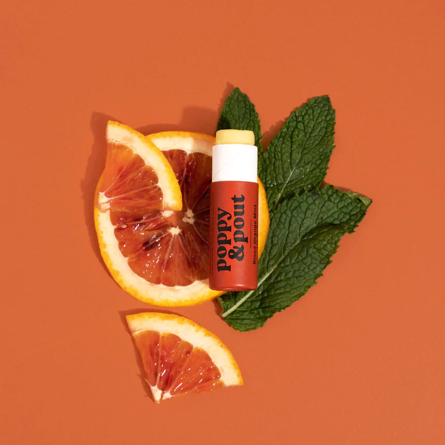 Balm with mint leaves and orange slices on an orange background