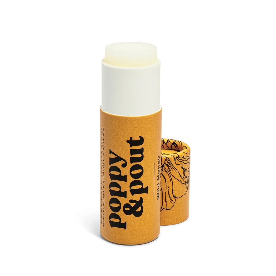 Lip balm with 'Poppy & Pout' branding on a white background
