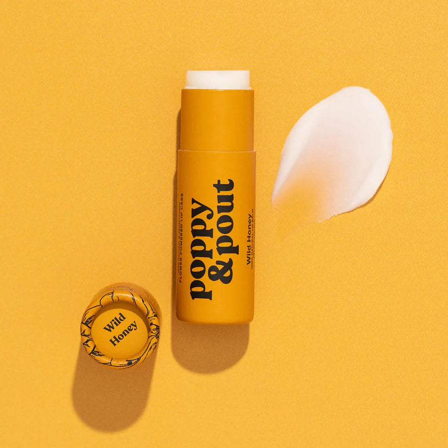 Yellow lip balm stick with 'Poppy & Pout' branding on a yellow background