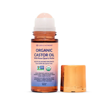 Organic castor oil roll-on bottle with rose quartz roller on a white background