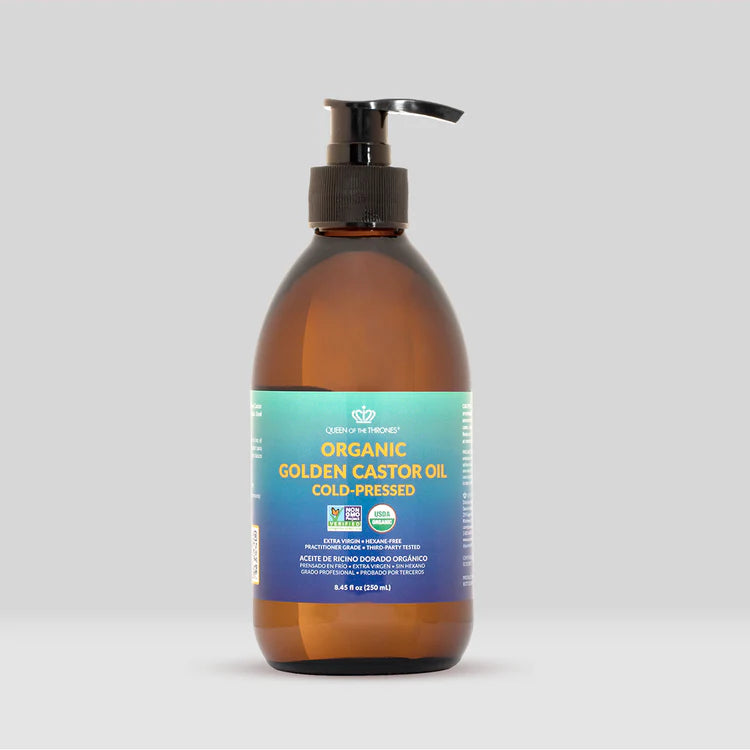 Brown bottle of organic golden castor oil with a pump on a light gray background