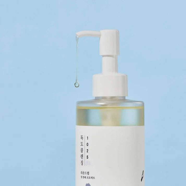 Skincare bottle with pump dispenser on a light blue background