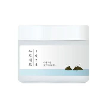 White jar with a label featuring text and a small illustration on a white background