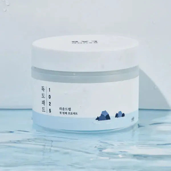 White jar with a label featuring text and a small illustration on a white background