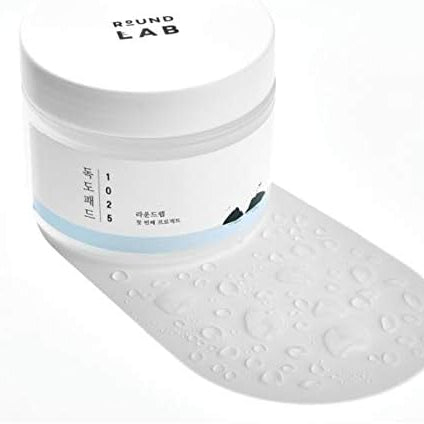 White shoe with a blue stripe and 'Round Lab' branding on a white background