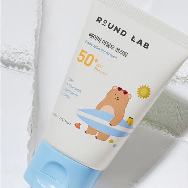 Round Lab baby mild sunscreen tube with bear illustration on a white background