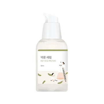 Skincare serum bottle with a white cap on a white background