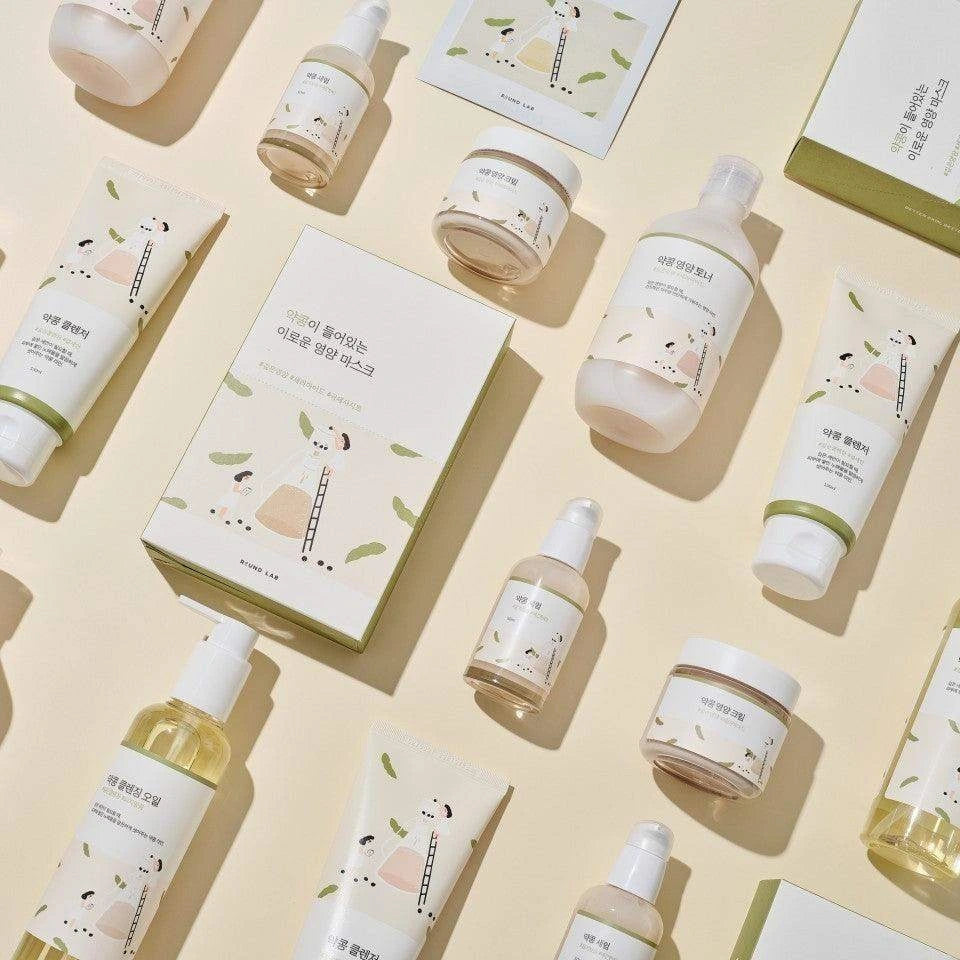 Skincare product set with bottles, jars, and boxes on a beige background