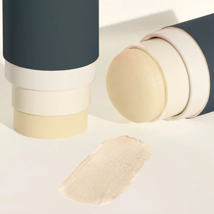 Cosmetic stick with applicator on a light background